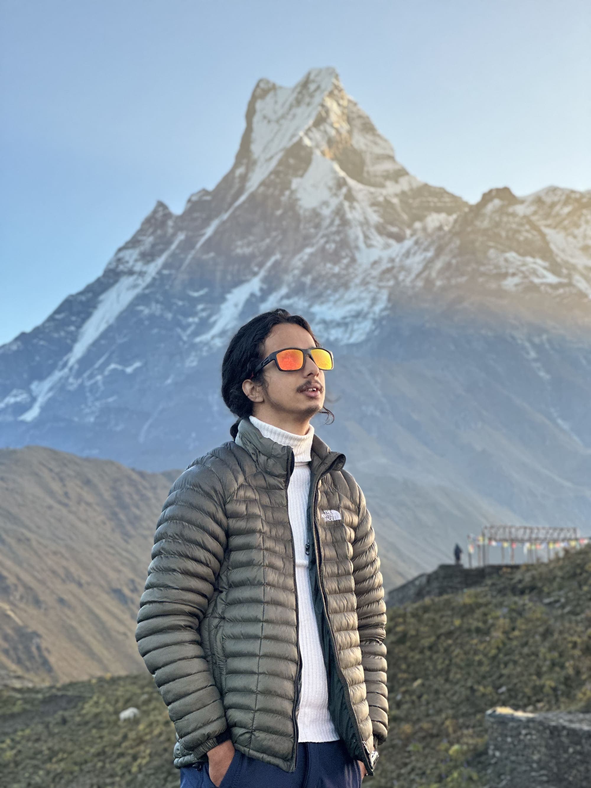 Bijaya Paudel, founder of Trek Everest Nepal, standing before Machapuchare (Fishtail) near Pokhara